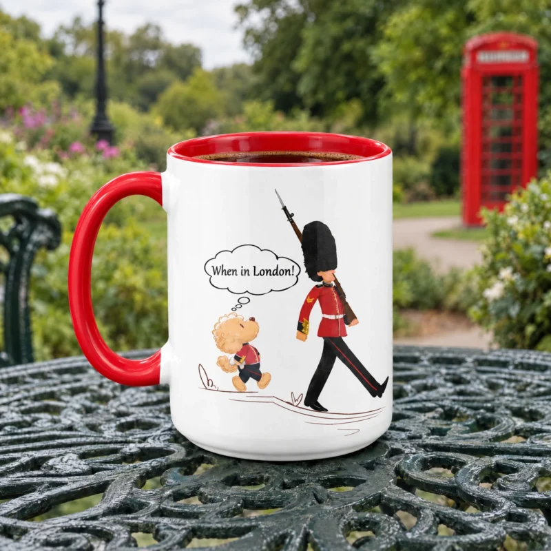 Red-handled 15 oz London ceramic mug with Ollie the dog, photographed on a garden table in London.