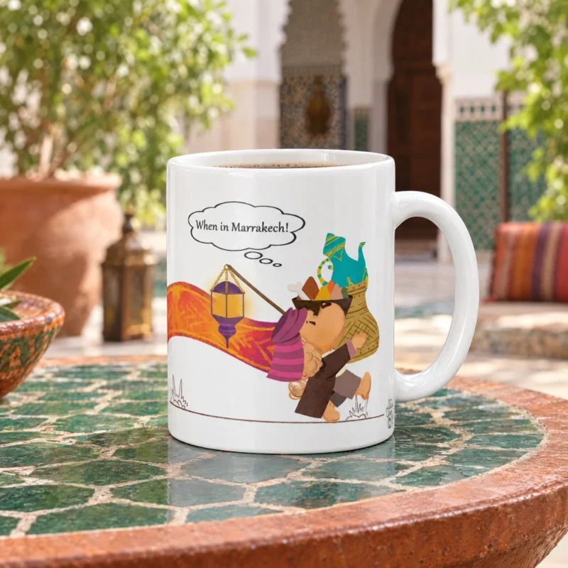 White 11 oz Marrakech ceramic coffee mug with Ollie the dog, photographed in a Marrakech-inspired setting.